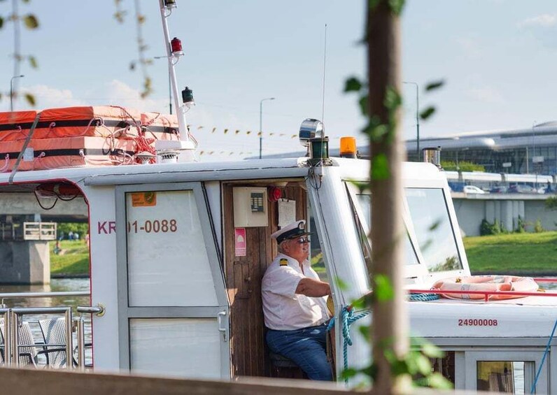 A stationary boat with a captain, a lifebuoy, and a bridge in the background. 3