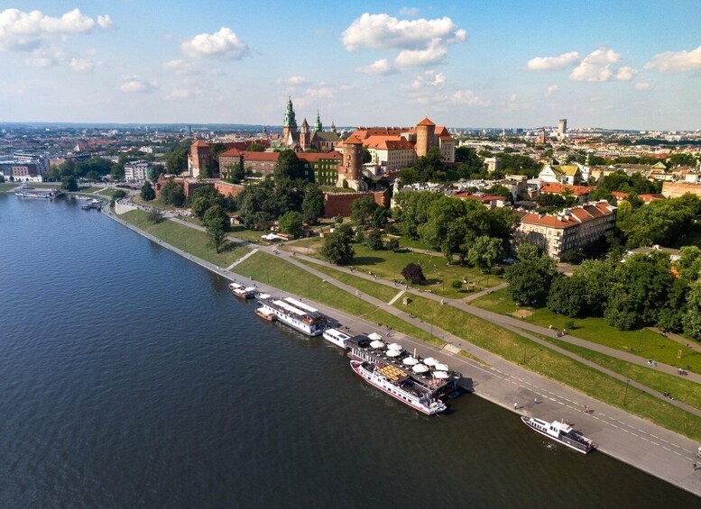 A river with boats, a castle, and a cityscape. 5