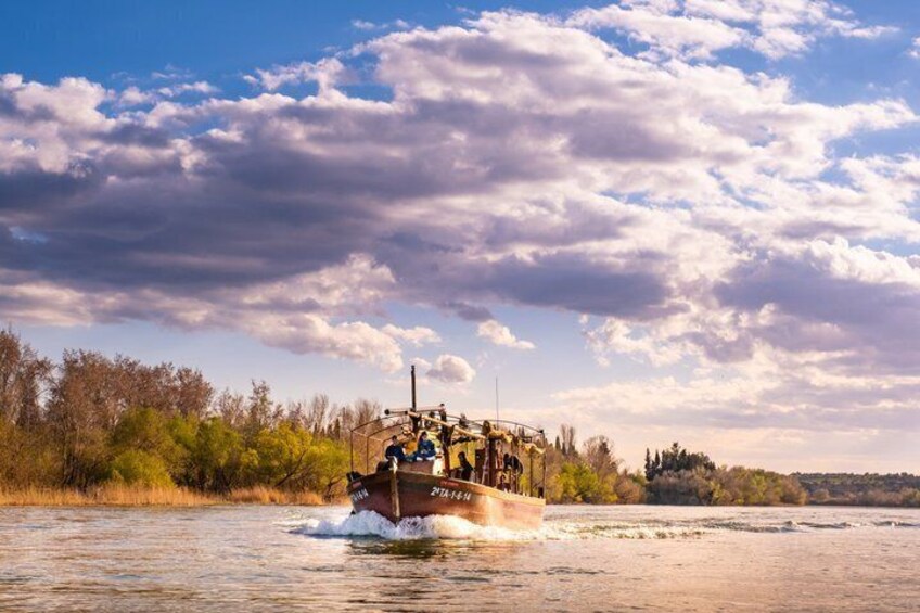 A boat with passengers moving through a river. 3