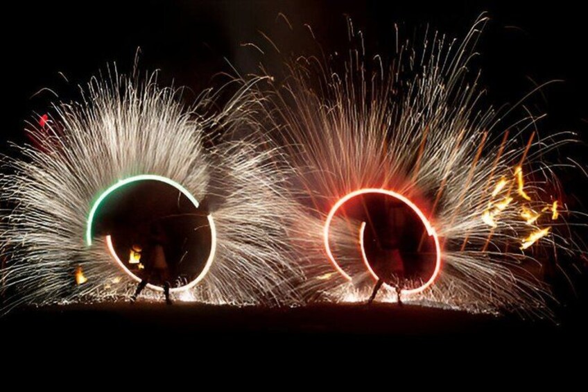 Two firework displays with circular patterns against a dark night sky. 2