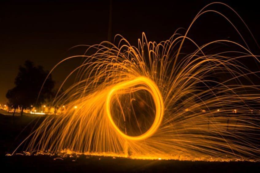 A night scene with a circular light trail pattern. 3