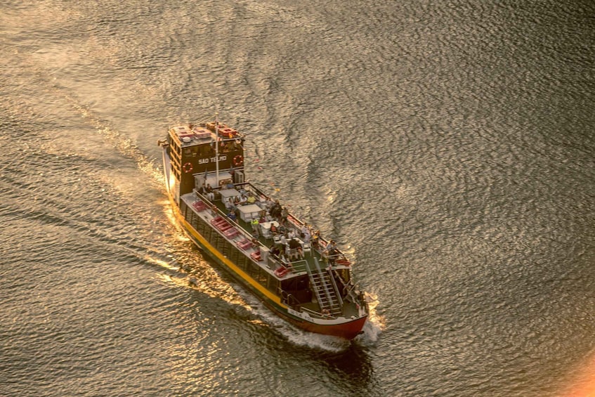 A large ferry boat with multiple decks and passengers, sailing on a body of water. 1