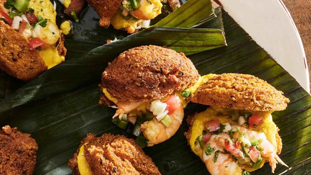 Sandwiches on a banana leaf with a side of salsa. 4