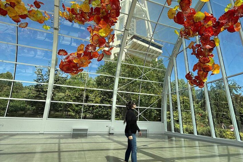 A large glass structure with a person walking inside. 2