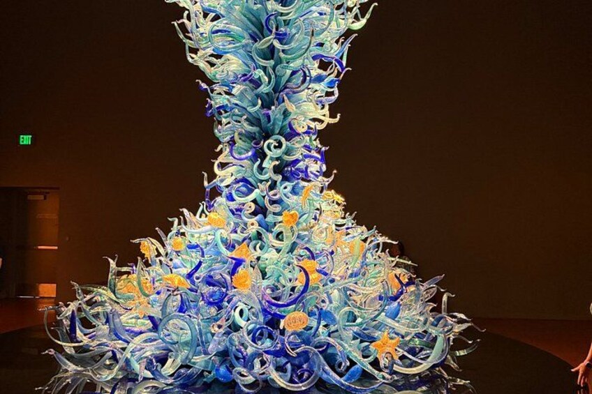 A large, intricate glass sculpture with swirling patterns and star-like elements. 4