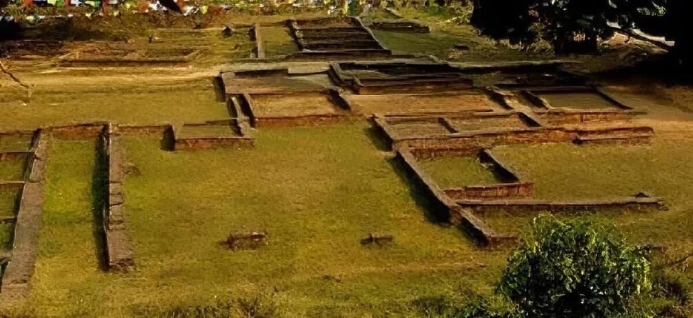 An archaeological site with terraced structures and pathways. 5