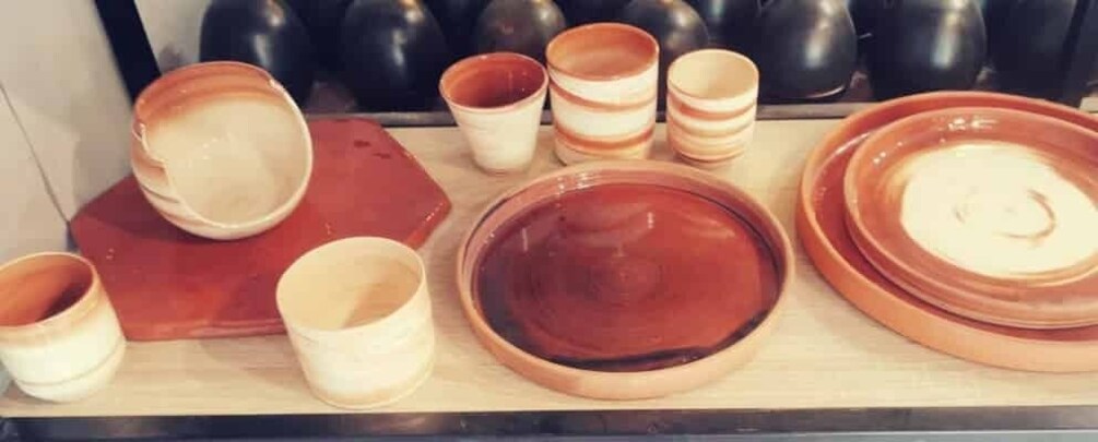 A variety of ceramic bowls and plates on a wooden surface. 4