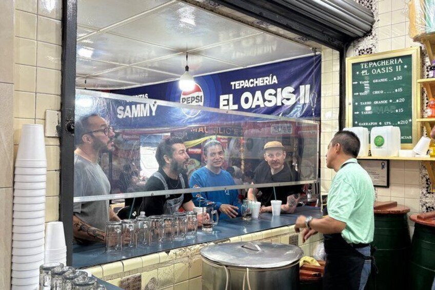 A food stall with a Pepsi advertisement and a menu board. 4