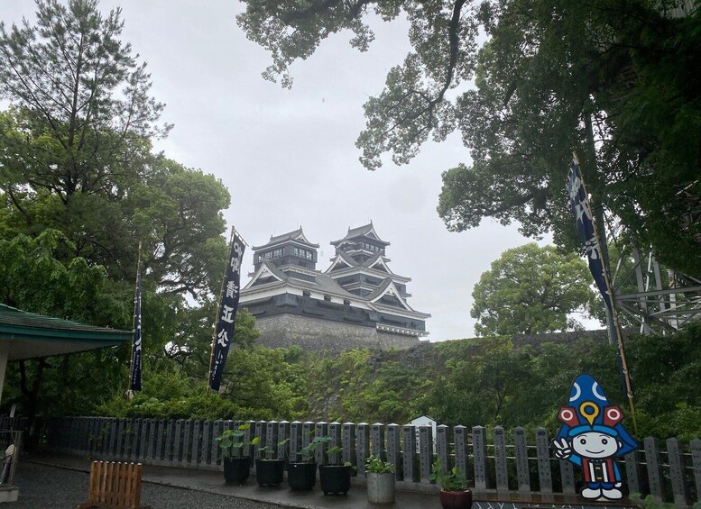 A traditional Japanese castle with multiple tiers and a surrounding forest. 2