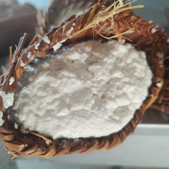 A woven basket filled with white powder, possibly flour or a similar substance. 1