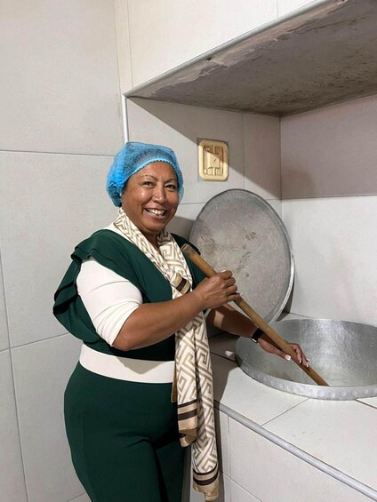 A person cooking with a large pot on a stove in a kitchen. 5