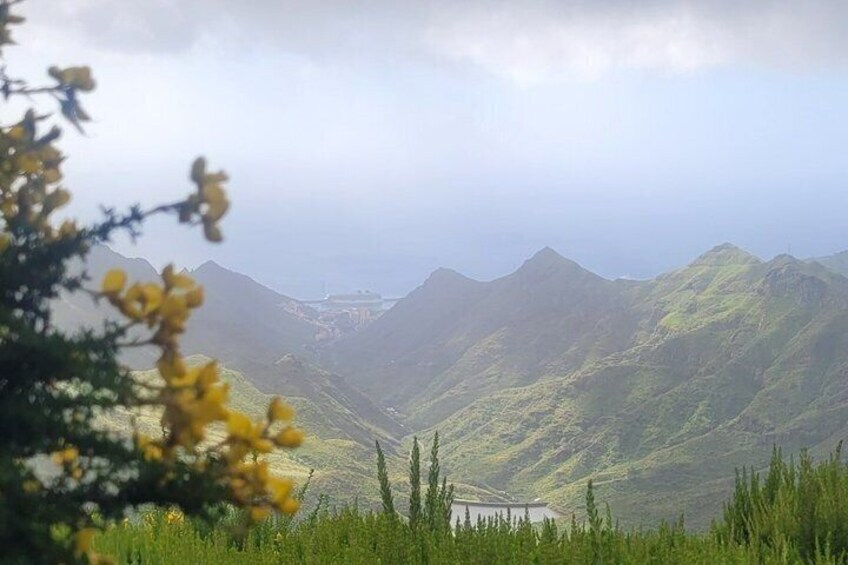 A mountainous landscape with a valley and a body of water. 3