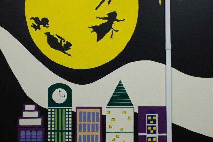 A stylized cityscape with buildings and a large yellow moon with silhouettes of flying creatures. 3