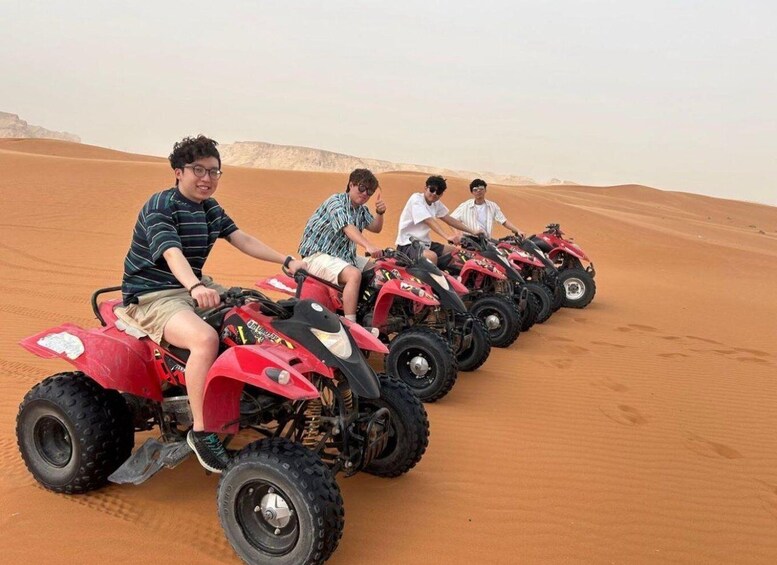 A group of people on ATVs in a desert. 2