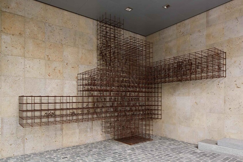 A metal sculpture with geometric shapes and a tiled floor. 3
