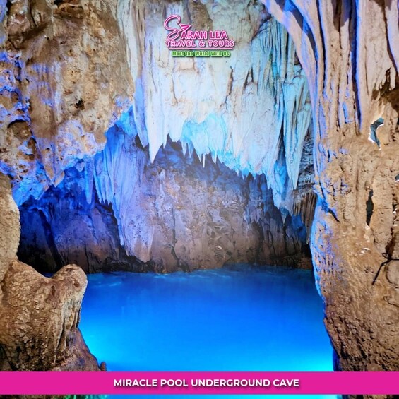 An underground cave with stalactites and a pool of water. 2