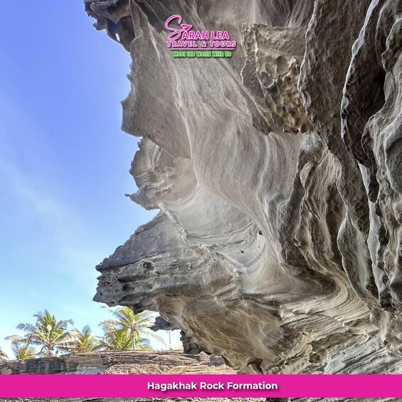 A large rock formation with a smooth, layered surface. 1