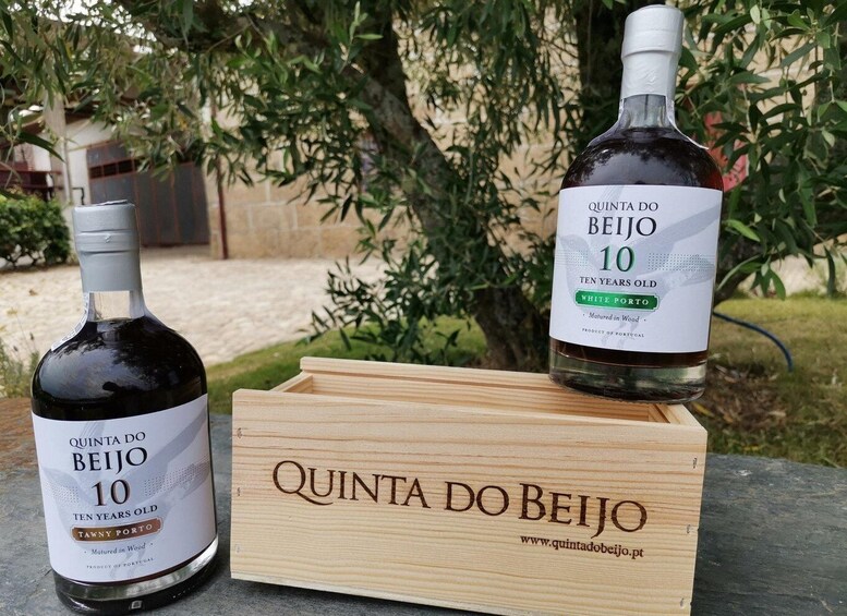 Two bottles of Quinta Do Beijo wine and a wooden crate with the same branding. 3