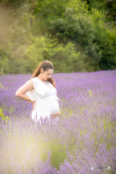 A pregnant woman in a field of lavender. 3