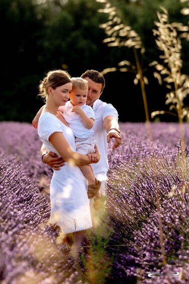 A family in a lavender field with tall plants. 5