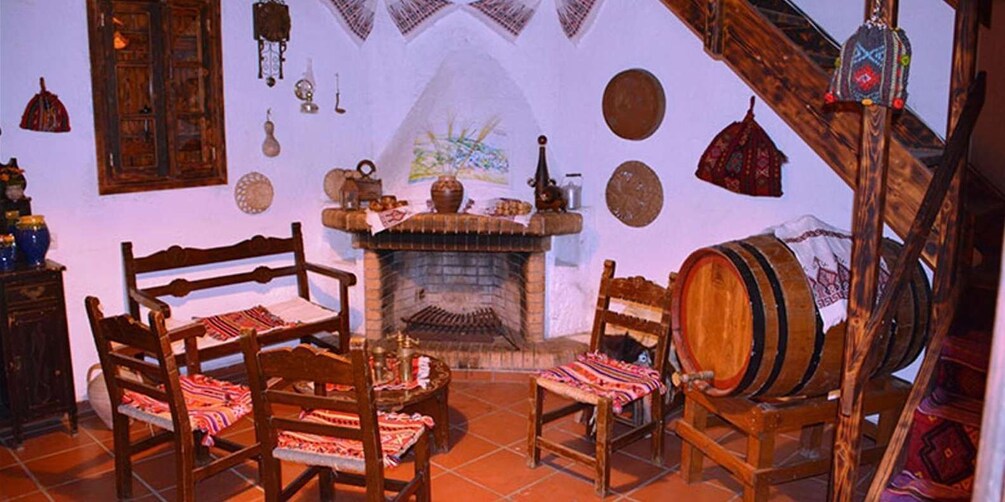 A rustic interior with wooden furniture, a fireplace, and traditional decor. 2