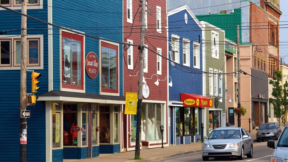 A street lined with colorful buildings, including a SmartShop and a Rascals store. 5
