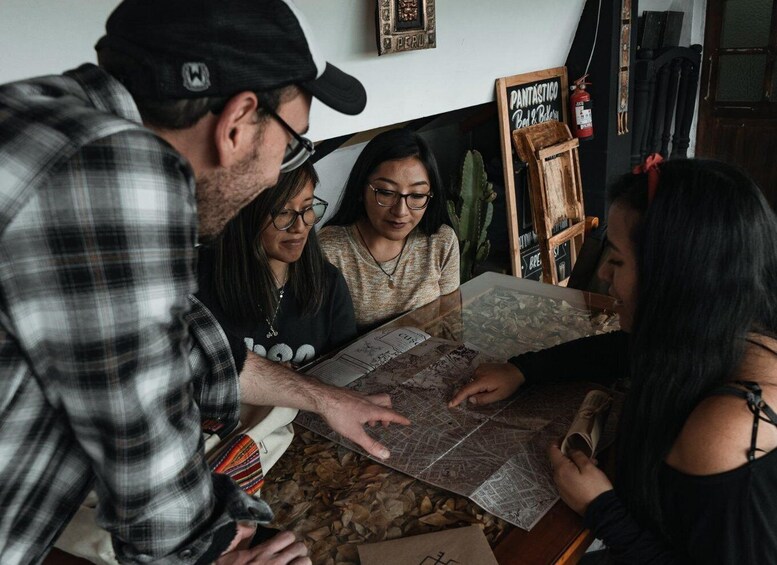 A group of people examining a map at a table. 3