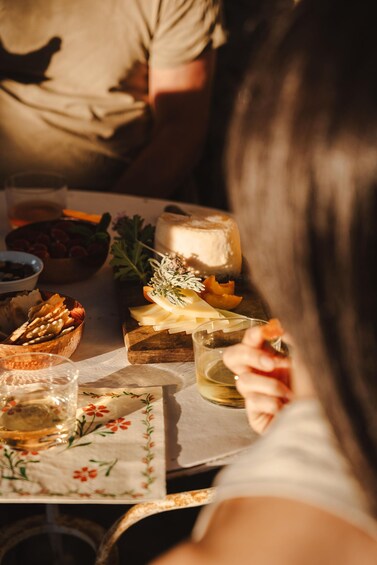 A table with cheese, crackers, and a glass of wine. 3