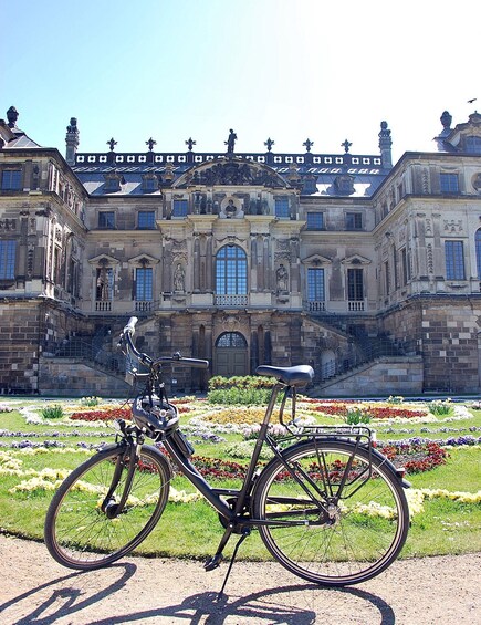A historic building with ornate architecture and a bicycle in the foreground. 5