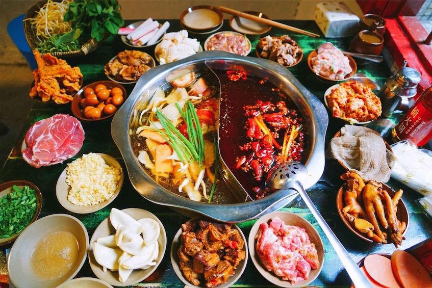 A variety of dishes including dumplings, meat, and vegetables, arranged on a table. 1