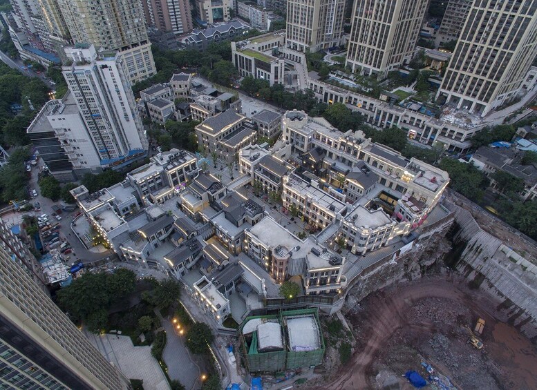 An urban area with high-rise buildings, a construction site, and a mix of commercial and residential structures. 2