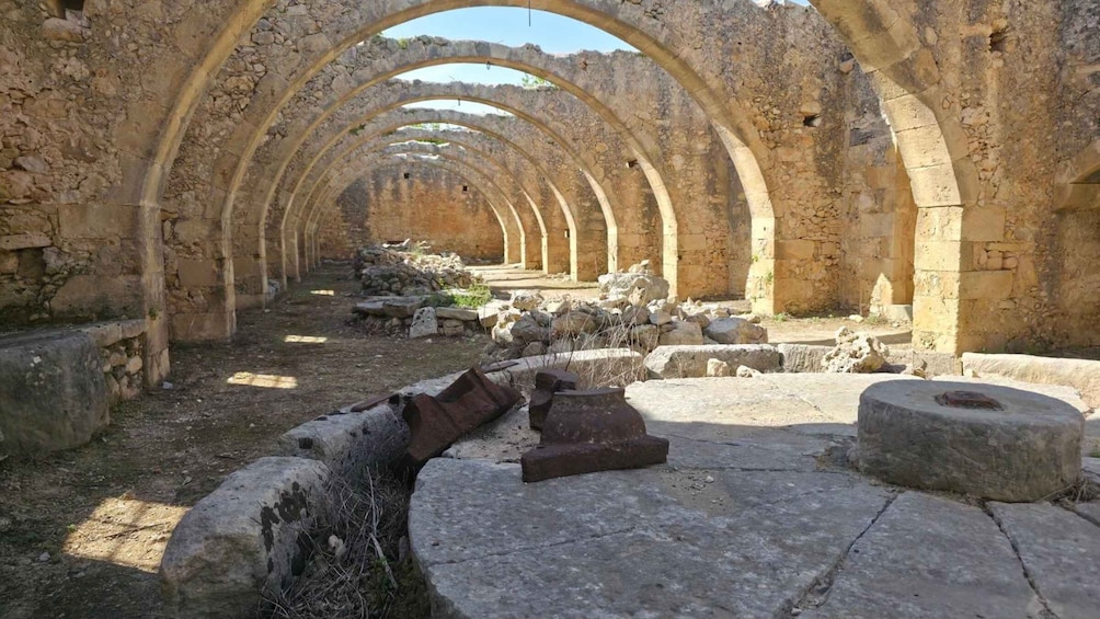 An ancient stone structure with arches and ruins. 5