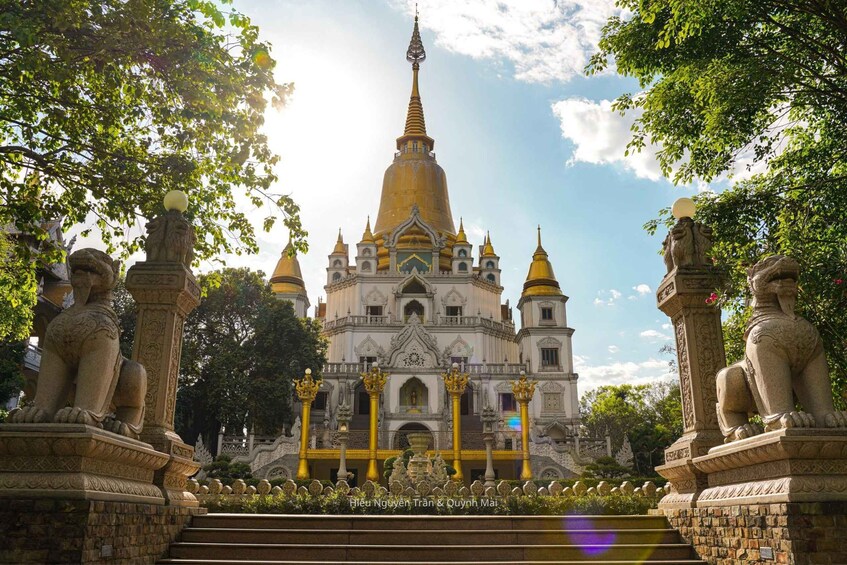 A temple with a golden spire, ornate statues, and a well-maintained garden. 3