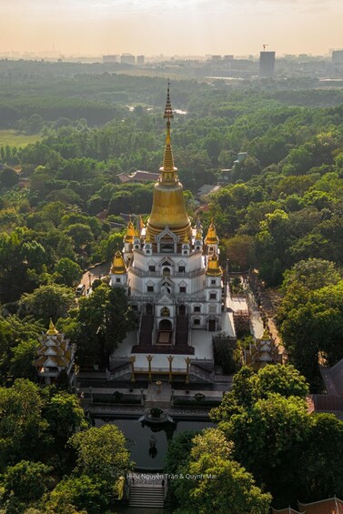 A temple complex with golden spires, surrounded by lush greenery. 2