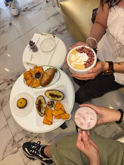 A table with food and drinks, including a dessert with whipped cream and a pink drink. 3