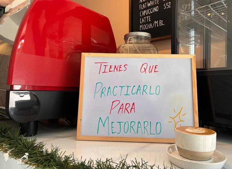 A coffee shop with a sign that reads 'Tienes que practicarlo para mejorarlo' and a cup of coffee on the counter. 2