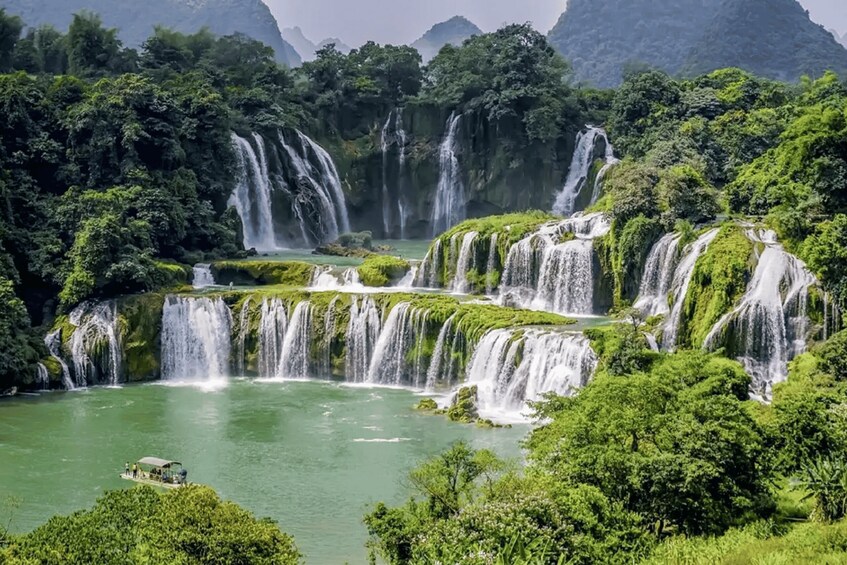 A series of waterfalls surrounded by lush greenery and a river. 2
