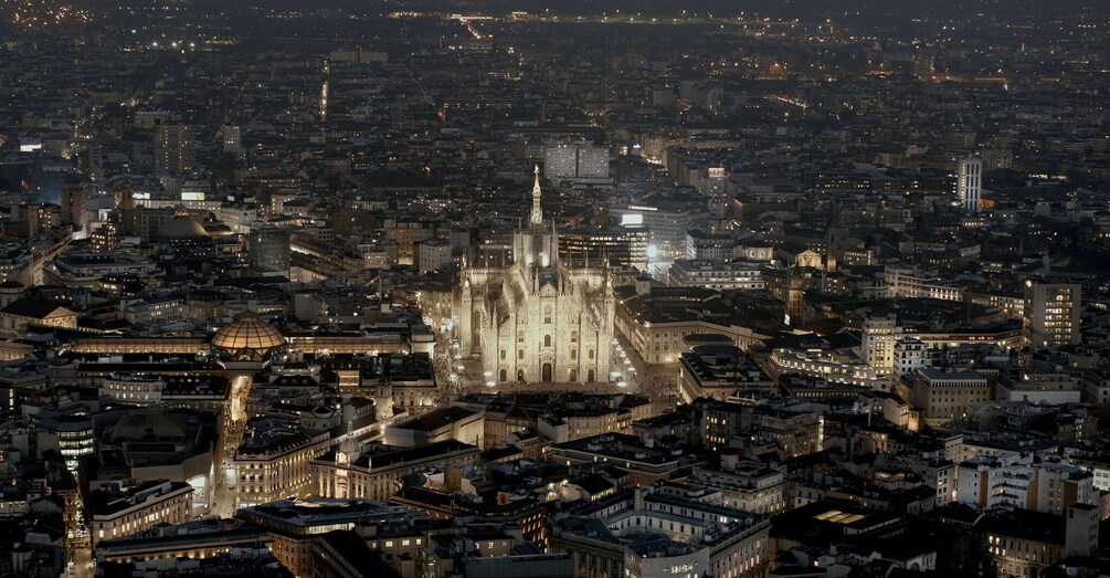 A nighttime cityscape with a prominent cathedral featuring Gothic architecture. 1