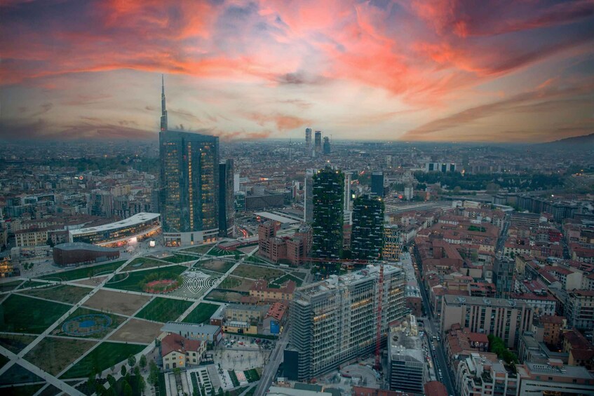 A cityscape with a prominent skyscraper, a large open square, and surrounding buildings. 3