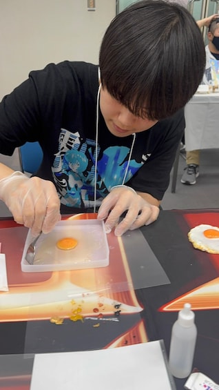 A person cutting an egg on a table. 5