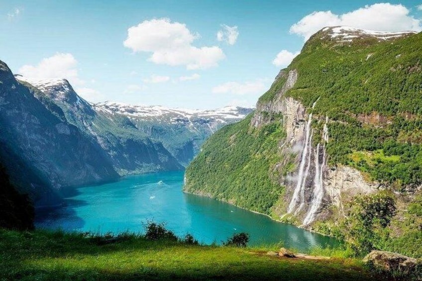 A fjord with waterfalls, a lake, and surrounding mountains. 4