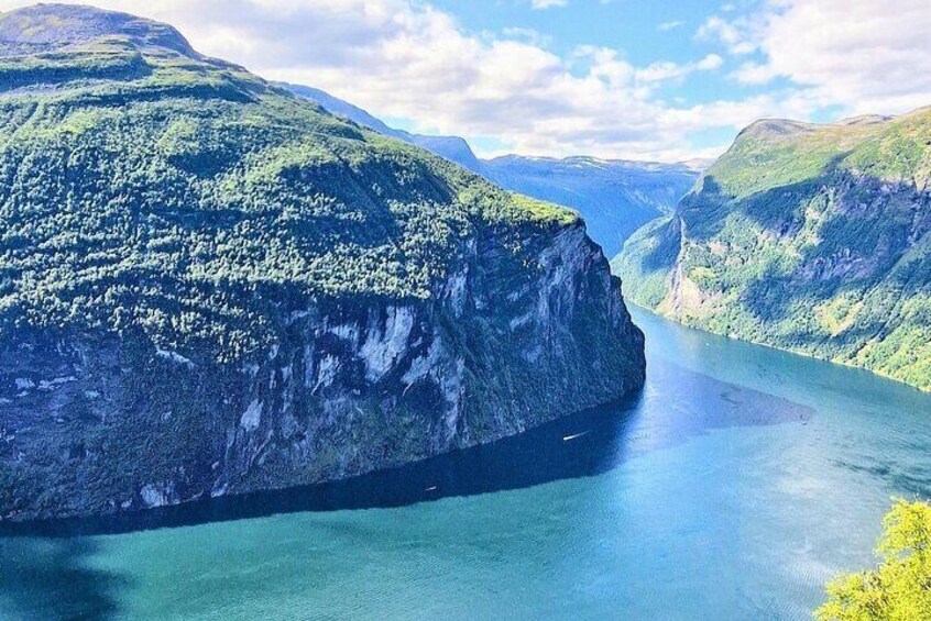 A river canyon with steep cliffs and dense greenery. 1