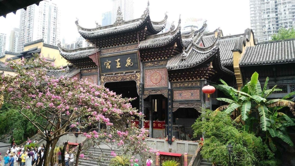 A traditional Chinese building with ornate architecture and a sign in Chinese characters. 1