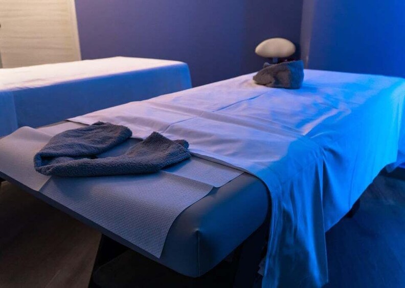A massage table with a towel and a massage head. 2