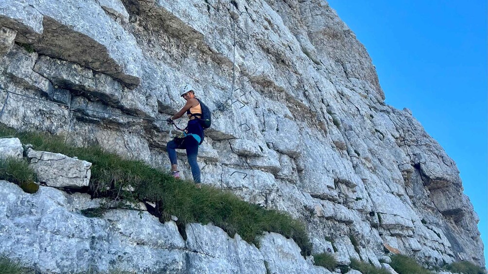 A person climbing a rocky cliff. 2