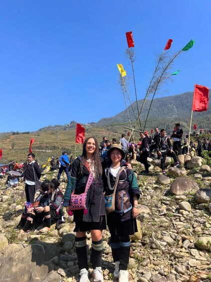 A group of people on a rocky hillside with flags. 4