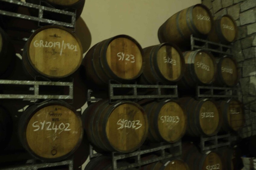 Wooden barrels stacked on shelves. 2