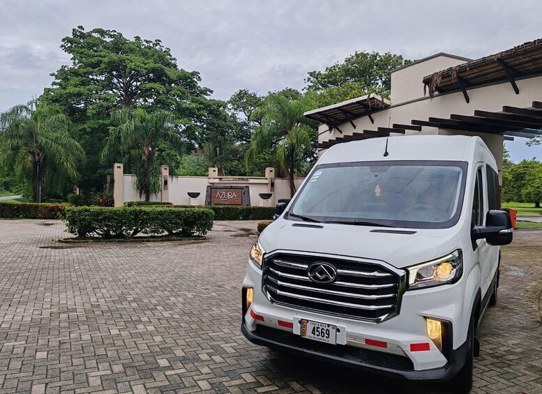A white Mercedes-Benz Sprinter van parked in front of a building with a sign reading 'AZURA.' 3