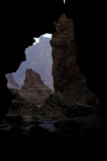 A rock formation with a cave entrance. 1