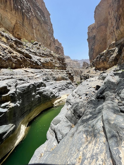 A canyon with a narrow water channel. 4